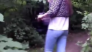 Desperate Brunette with Long Legs in Tight Jeans Walking Trough Forest Searching for a Place to Pee