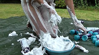 Outdoor solo masturbation scene with curly blonde