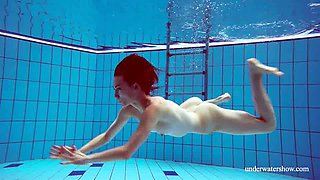 Amateur thin chick exposes her small tits right underwater in the pool