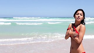 Asian MILF and brunette strip at beach