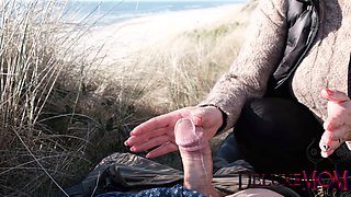 Milf Deluxemom gives a beach handjob while getting splooged on during dune fun
