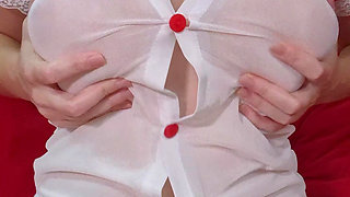 Pretty girl in transparent dress and blonde hair plays with her big tits . Amateur Video Close-Up