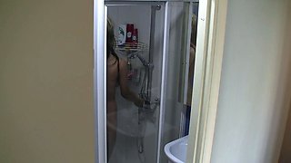 Spy cam watches chick shower