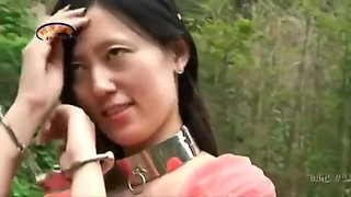 Chinese Beauty In Metal Bondage Outdoors