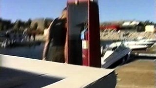 In a kitchen a sexy brunette playing with her big boobs