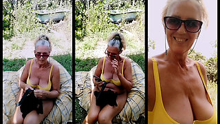 Hot housewife Lukerya in the fresh air in the summer in the yard.