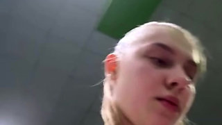 Public masturbation: A horny beauty at the FIT gym massages her pussy and cums on a bench in the locker room.