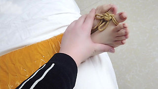 First-person Perspective Records the Girlfriend Wrapped in Tape From Head to Toe with Her Beautiful Bare Feet