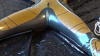 Latex Danielle is attached to the bed and masturbated with the massage vibrator