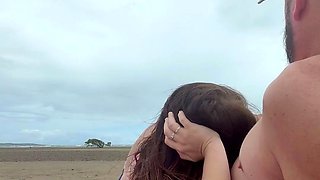 Sucking his cock on the beach for everyone to see.