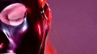 Cute rubber slut deepthroats double dildo