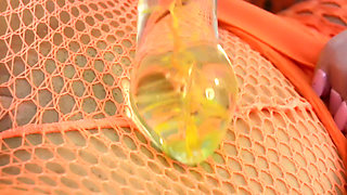 Glass Dildo Solo in an Orange Fishnet Bodysuit - Busty Brunette Plays on the Couch