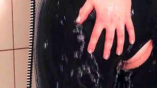 Wet MILF washing in latex rubber catsuit, pussy ass tease