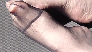 Feet of Nylonjunge in Pantyhose in Car
