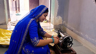 Indian wife sewing on the machine but she has other thoughts too.