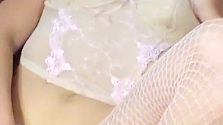 Curly Brunette in White Fishnets with a Purple Vibrator