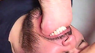 3 Girls Shoving Their Feet Into a Submissive Guy's Mouth.