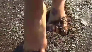 Alone lush Russian babe toys her cunt on the rock on the sea shore