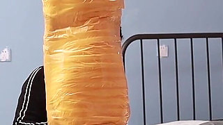 A Cute Barefoot Girlfriend Uses Tape to Bind Her Whole Body, Playing with Her Cute Bare Feet