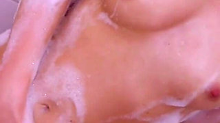 Hot blonde Daniella Margot fucks herself with a finger in the bath