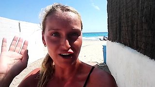 Outdoor solo masturbation scene with curly blonde